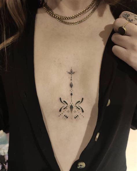 between chest tattoo female|Cross in between chest tattoo female